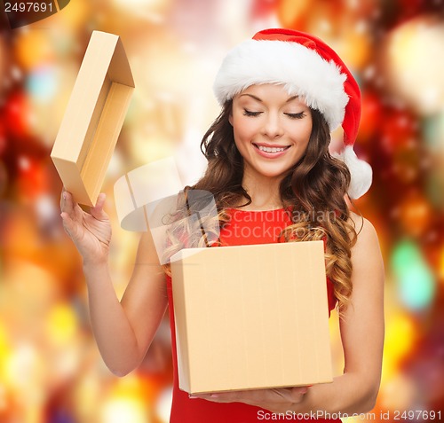 Image of smiling woman in santa helper hat with gift box