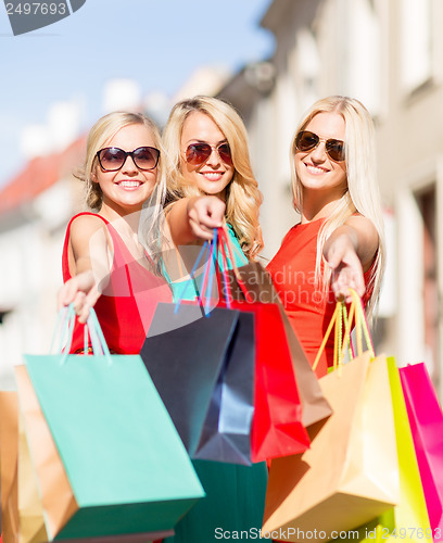 Image of beautiful women with shopping bags in the ctiy