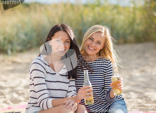 Image of girls with drinks on the beach