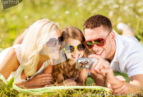 Image of happy family with camera taking picture