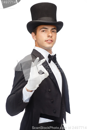 Image of magician in top hat showing trick