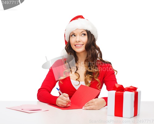 Image of smiling woman in santa helper hat with postcard