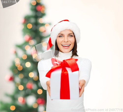 Image of smiling woman in santa helper hat with gift box