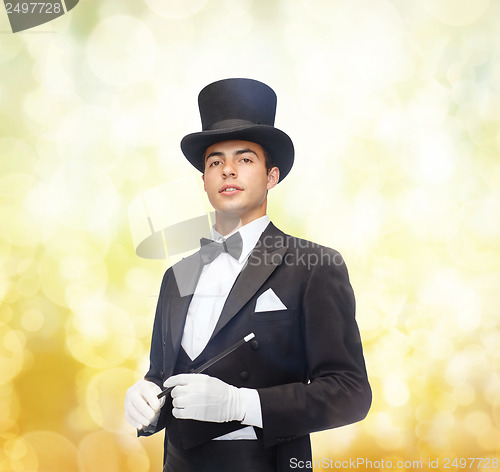 Image of magician in top hat with magic wand showing trick