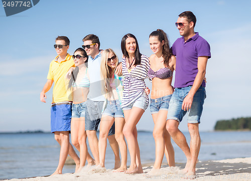 Image of group of friends having fun on the beach