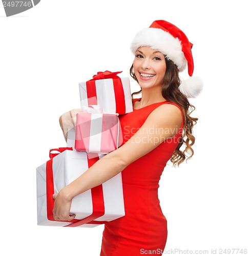 Image of smiling woman in red dress with many gift boxes