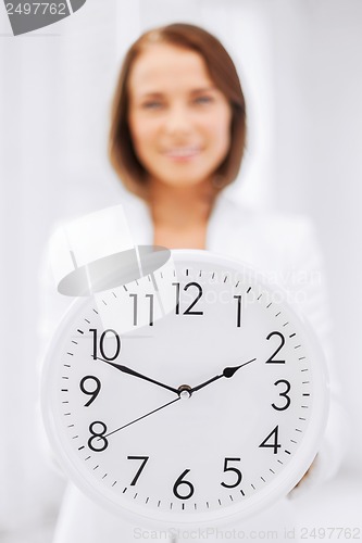 Image of attractive businesswoman with white clock