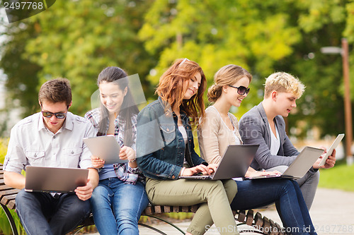 Image of students or teenagers with laptop computers