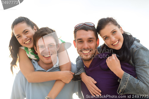 Image of group of friends having fun on the beach