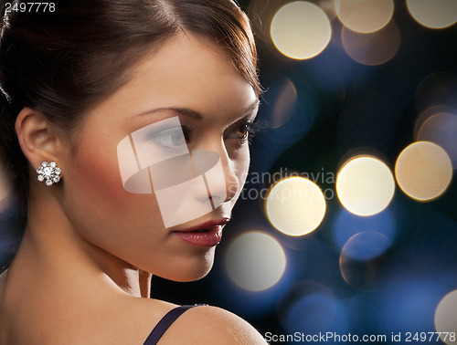 Image of woman in evening dress wearing diamond earrings