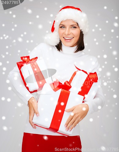 Image of woman in santa helper hat with many gift boxes