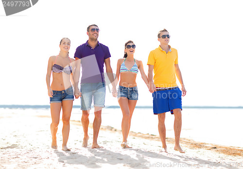 Image of group of friends having fun on the beach