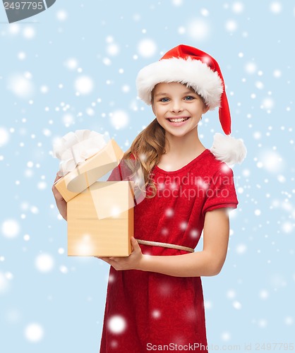 Image of smiling girl in santa helper hat with gift box