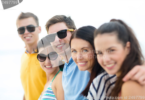 Image of group of friends having fun on the beach