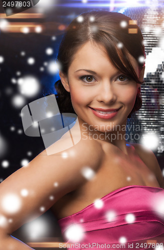 Image of woman in evening dress wearing diamond earrings