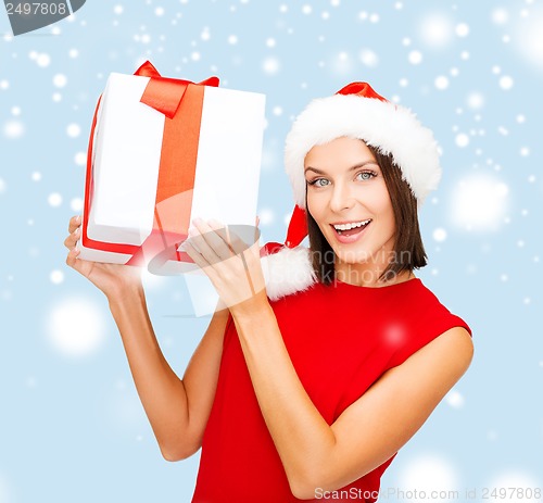 Image of smiling woman in santa helper hat with gift box