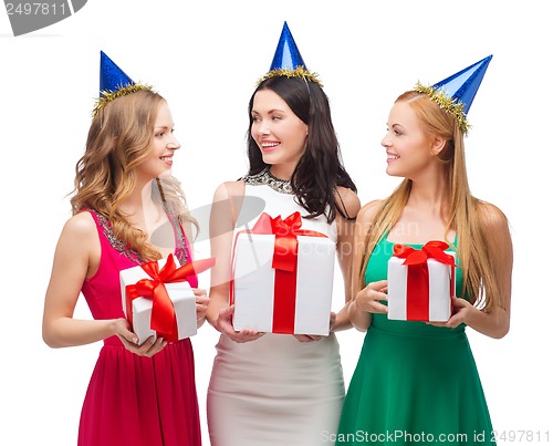 Image of three smiling women in blue hats with gift boxes