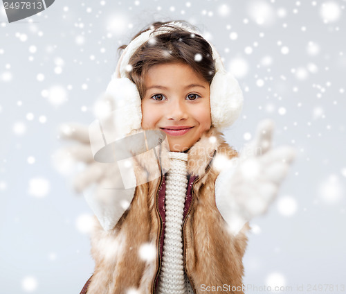 Image of happy littl girl in winter clothes