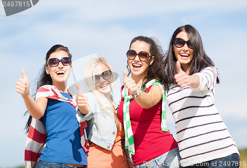 Image of teenage girls or young women showing thumbs up