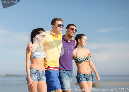 Image of group of friends having fun on the beach