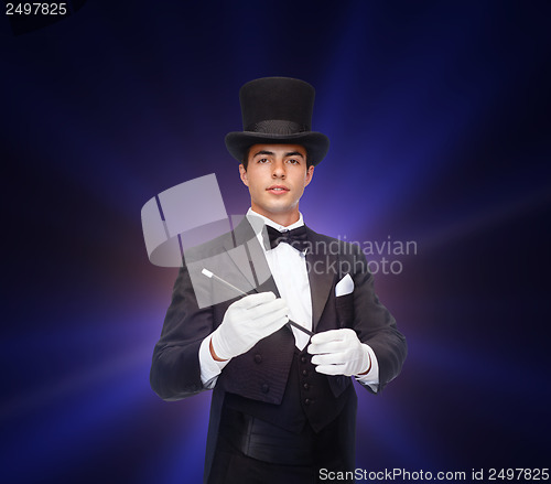 Image of magician in top hat with magic wand showing trick