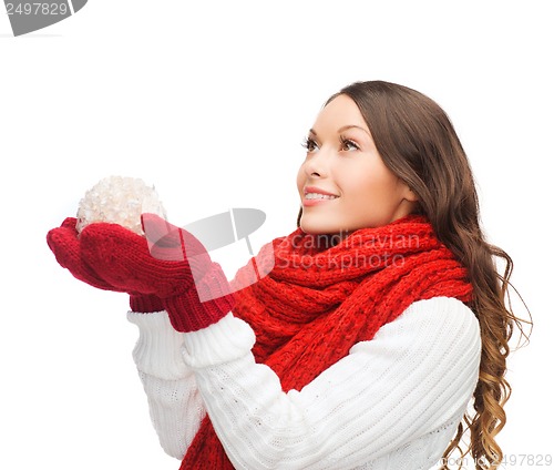 Image of woman in scarf and mittens with christmas ball