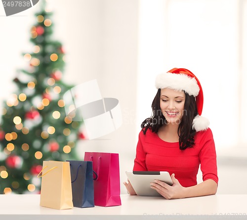 Image of woman with gift box and tablet pc computer