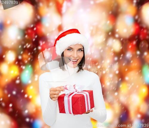 Image of smiling woman in santa helper hat with gift box