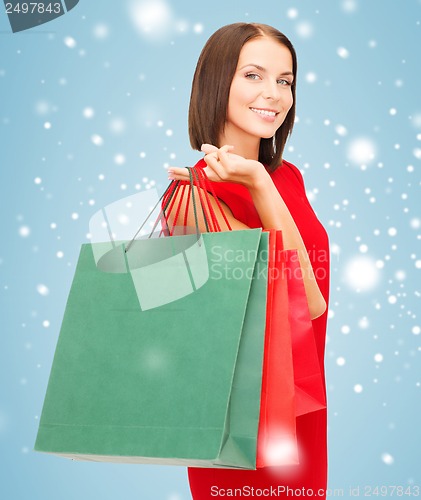 Image of woman in red dress with shopping bags