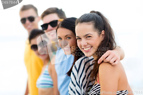 Image of group of friends having fun on the beach