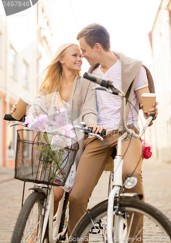 Image of couple with bicycles in the city