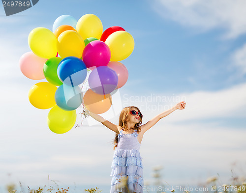 Image of happy girl with colorful balloons