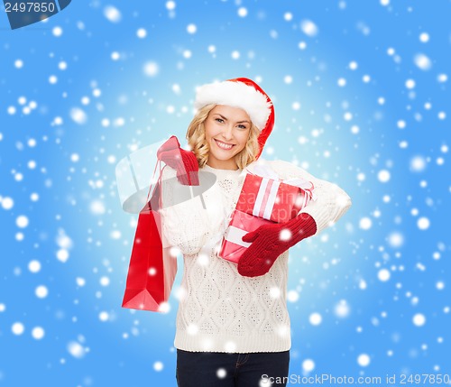Image of woman in santa helper hat with shopping bags