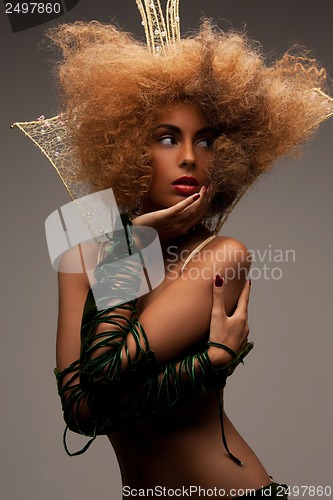 Image of woman with long curly hair in crown