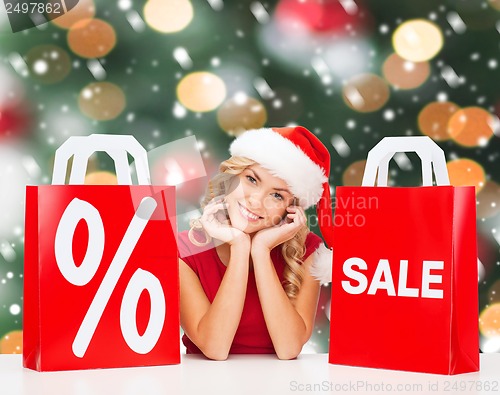 Image of woman in red dress with shopping bags