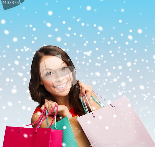 Image of woman in red dress with shopping bags