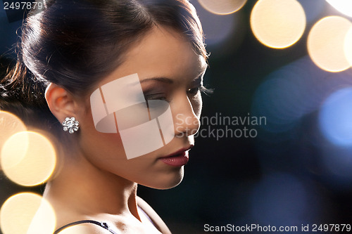 Image of woman in evening dress wearing diamond earrings