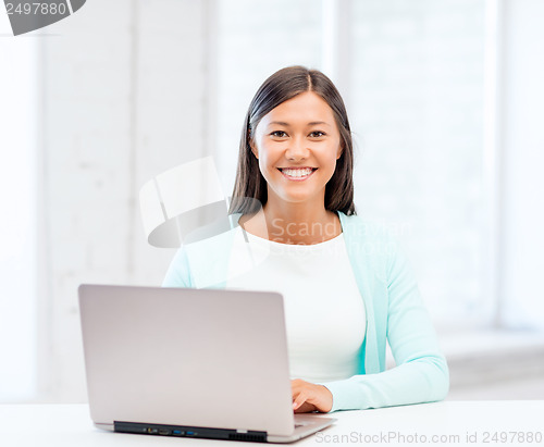 Image of international student girl with laptop at school