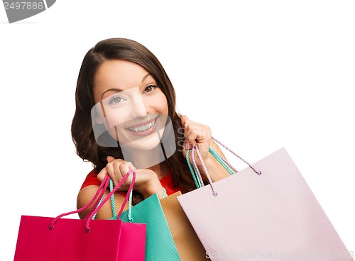 Image of woman in red dress with shopping bags