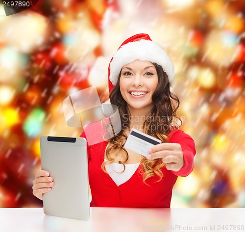 Image of woman with gift, tablet pc and credit card