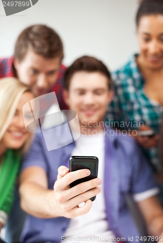 Image of students looking at smartphone at school