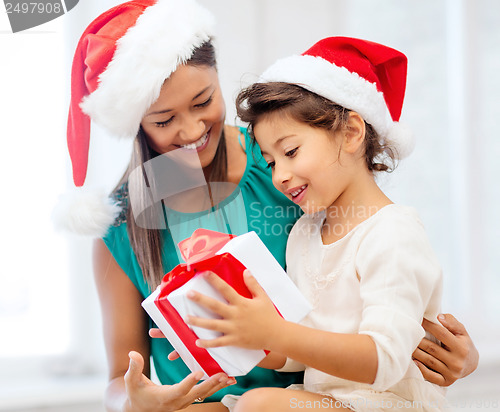 Image of happy mother and child girl with gift box