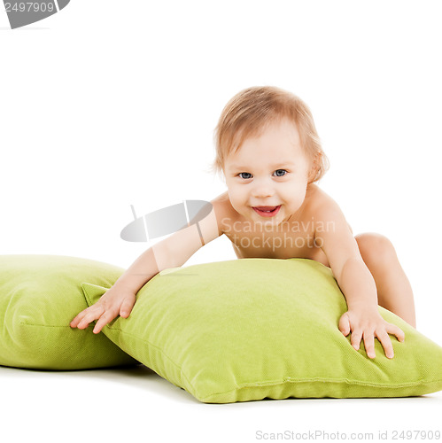 Image of cute little boy playing with green pillows