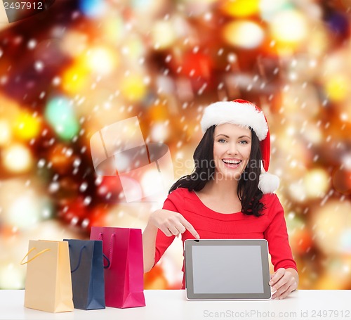 Image of woman in santa helper hat with tablet pc