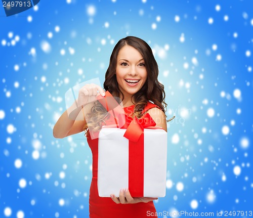Image of smiling woman in red dress with gift box