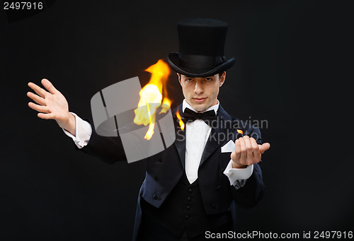 Image of magician in top hat showing trick with fire