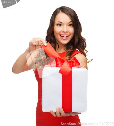 Image of smiling woman in red dress with gift box
