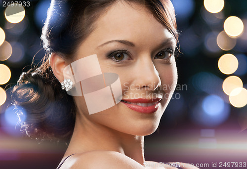 Image of woman in evening dress wearing diamond earrings