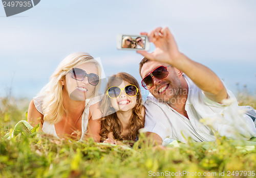 Image of happy family with camera taking picture