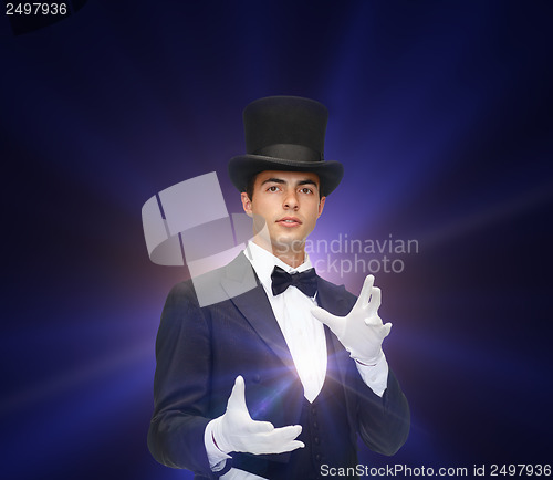 Image of magician in top hat showing trick